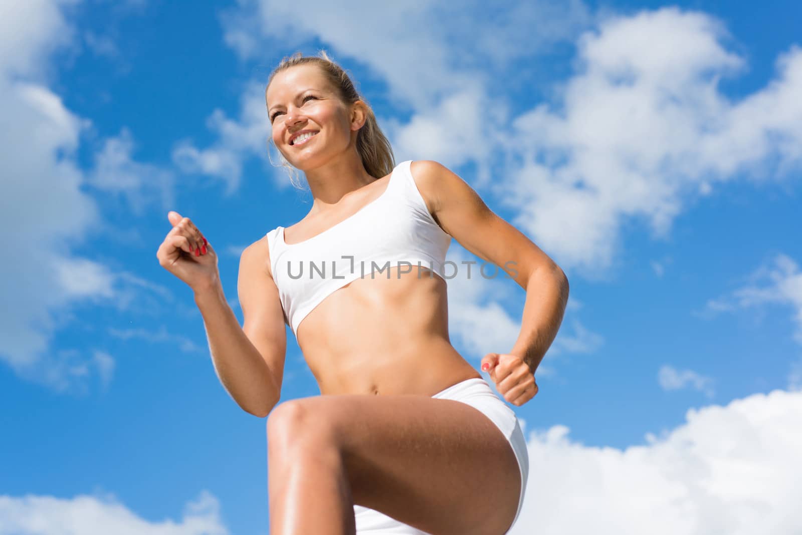 Young sports woman likes to run, view from below