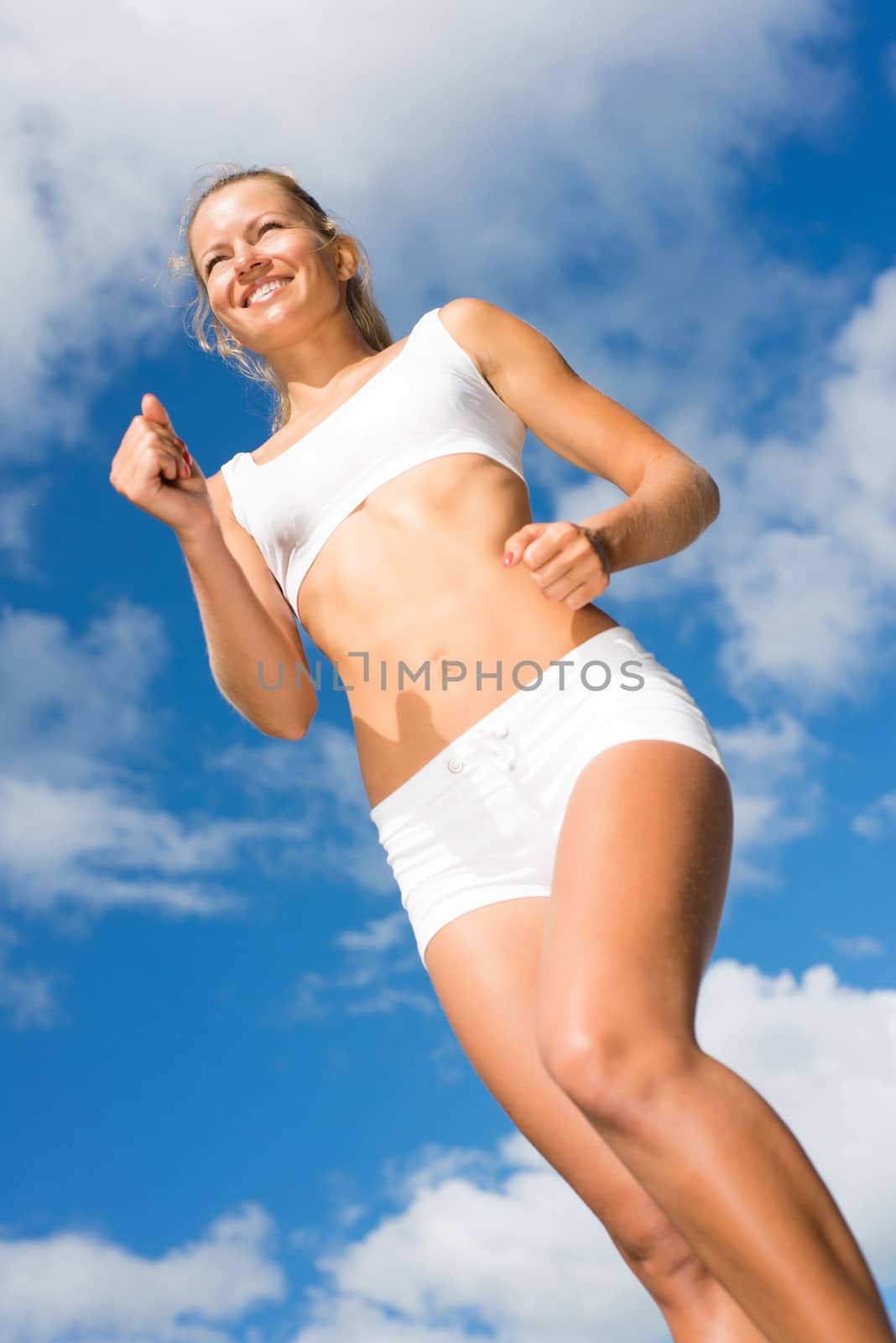 Young sports woman likes to run, view from below