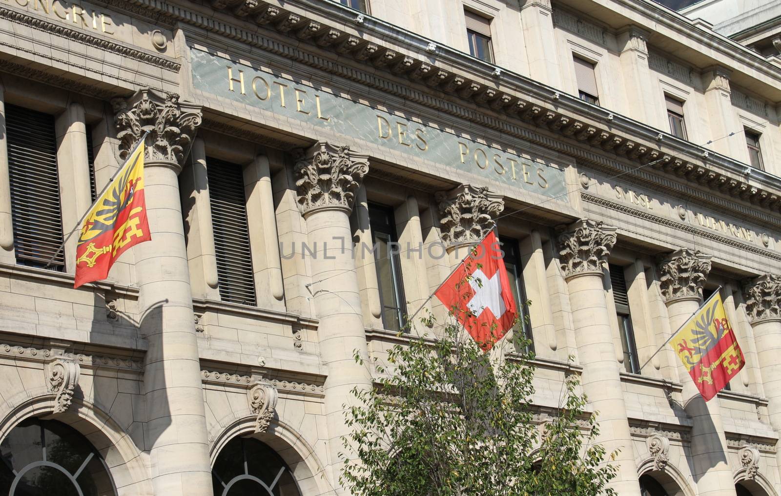 Close up on old post office building with Geneva and swiss flags, Switzerland