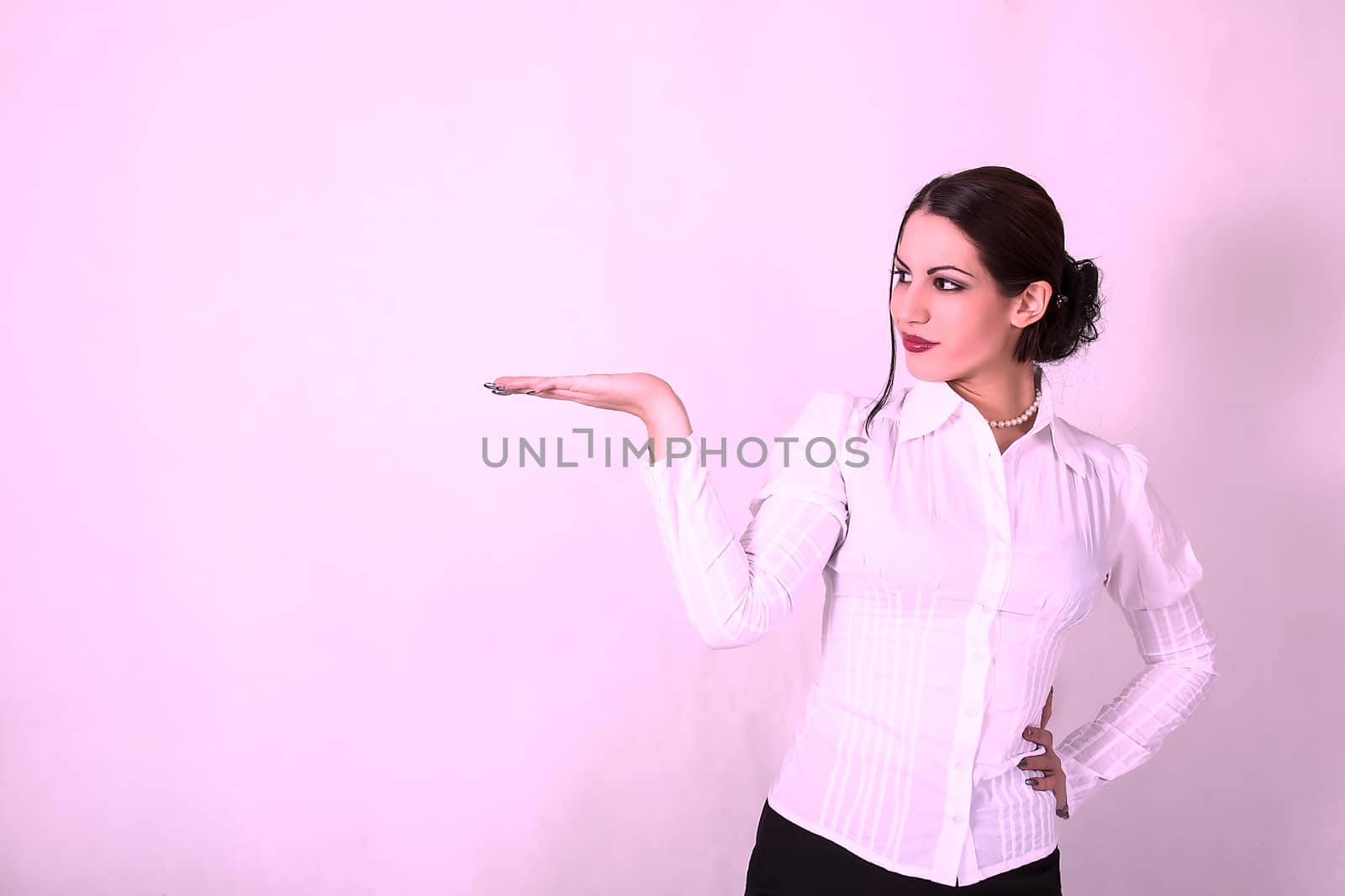 Young woman in business suit shows her empty palm by dukibu