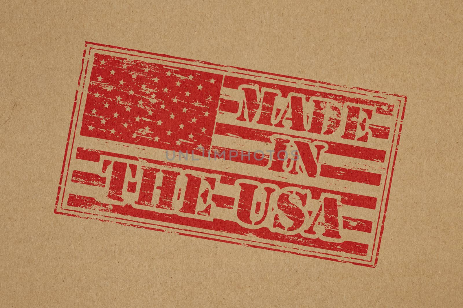 Made in the USA rubber stamp impression on brown paper background
