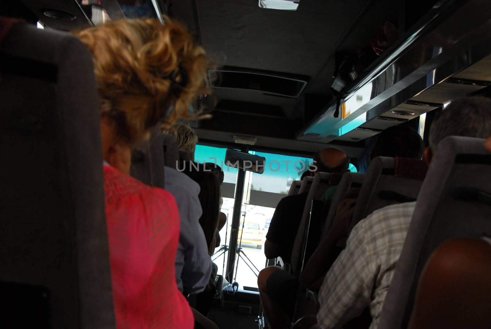 tourists travelling by bus from passage between seats rows