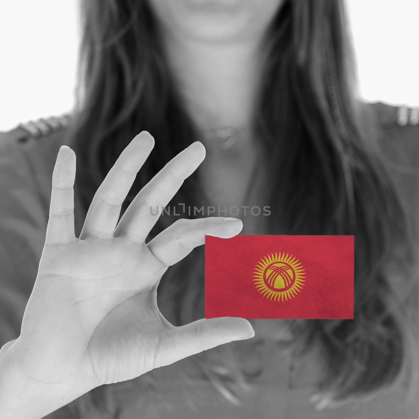 Woman showing a business card, flag of Kyrgyzstan