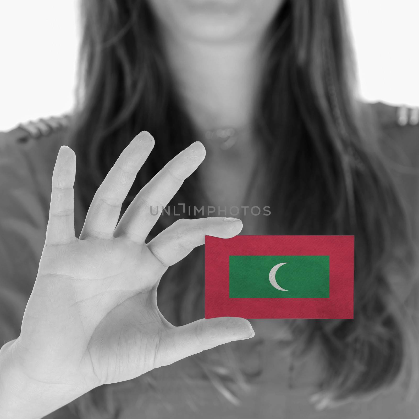 Woman showing a business card, flag of Maldives