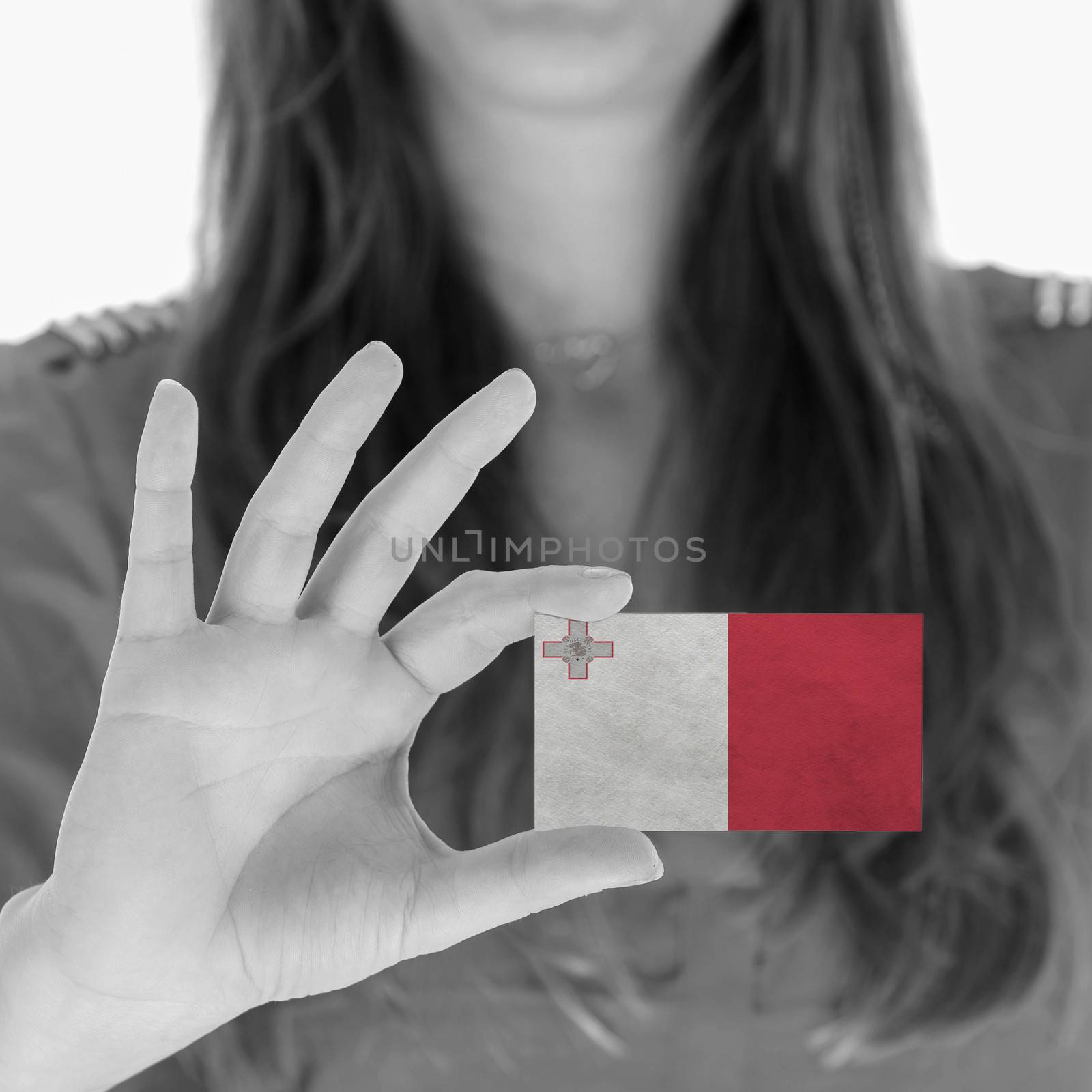 Woman showing a business card, flag of Malta