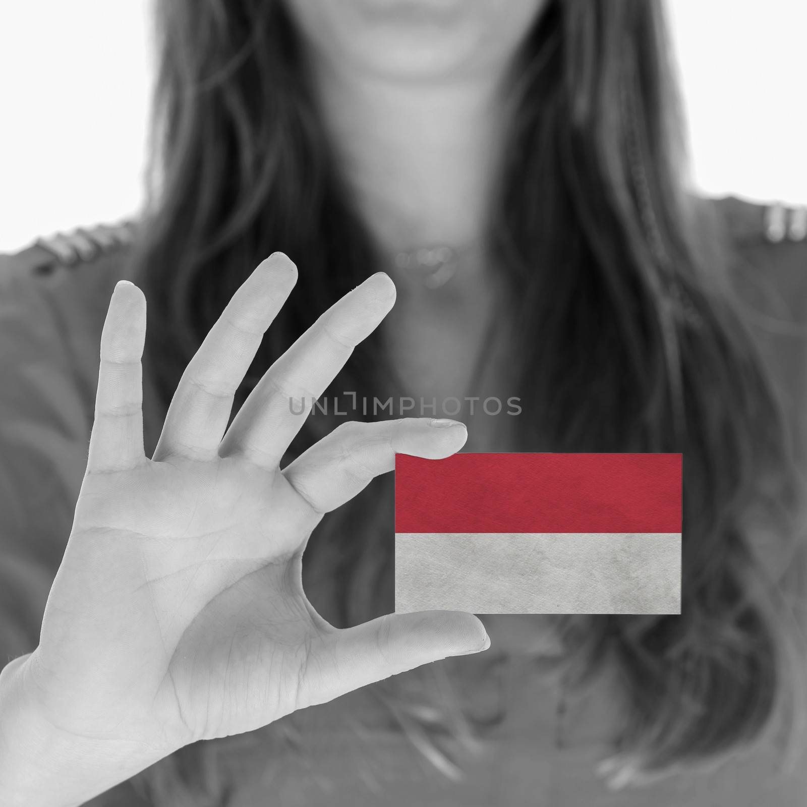 Woman showing a business card, flag of Monaco