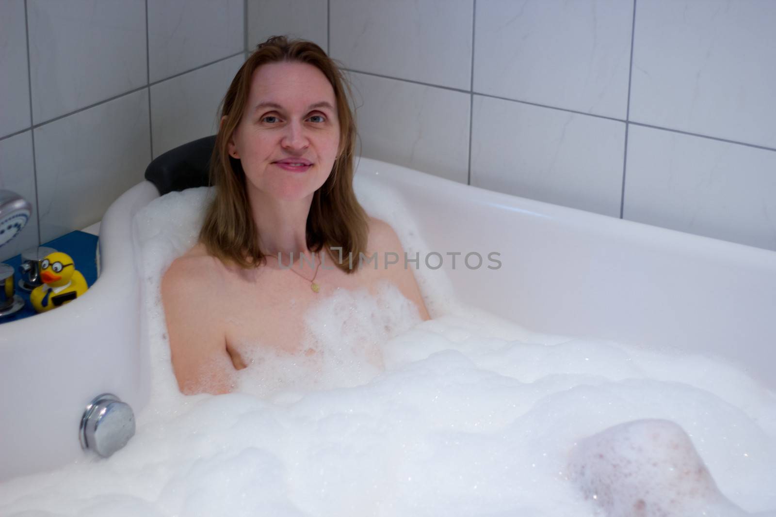 Having nice bath with lot of foam against stress