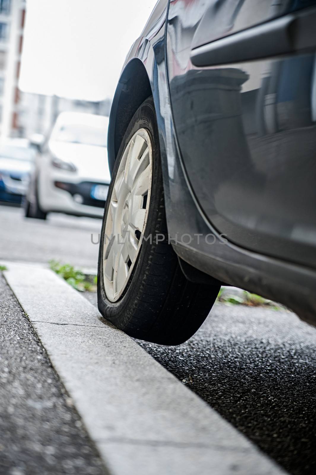 Incorrect parking car with tire on sidewalk