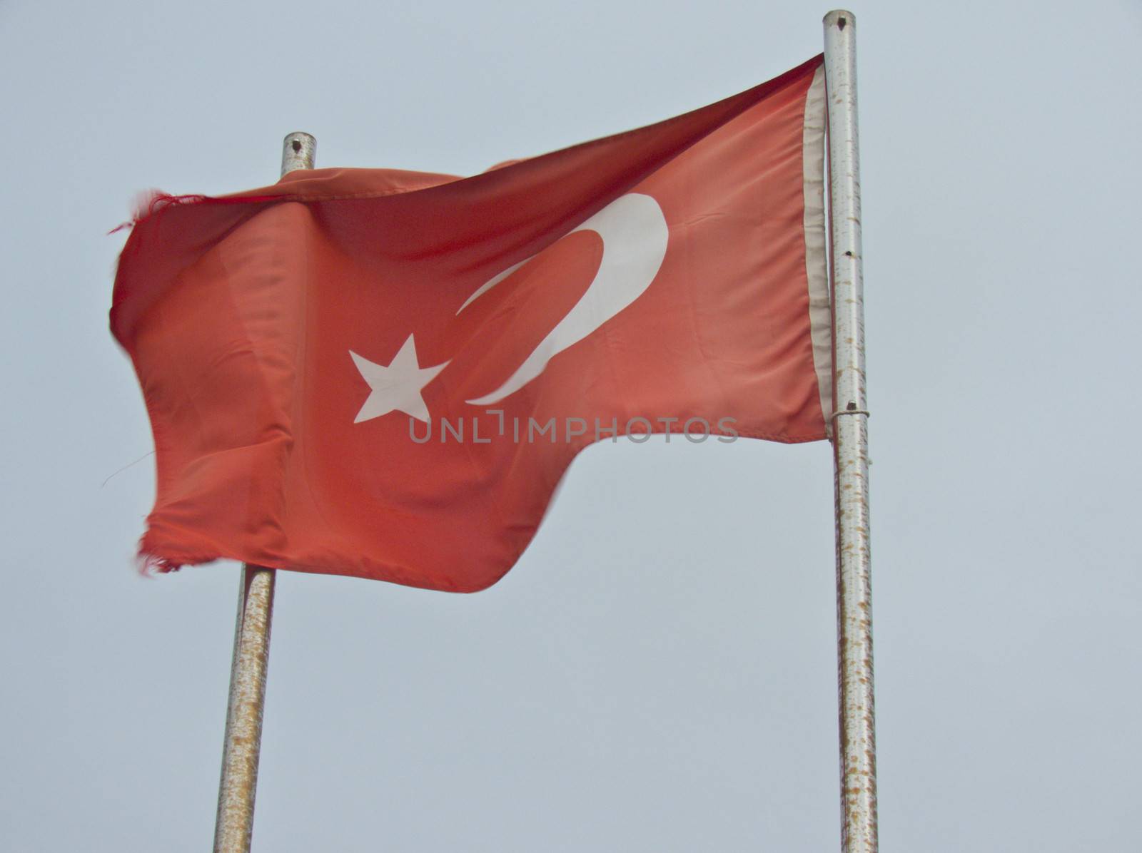 Scarlet Turkish flag flies from the strong wind