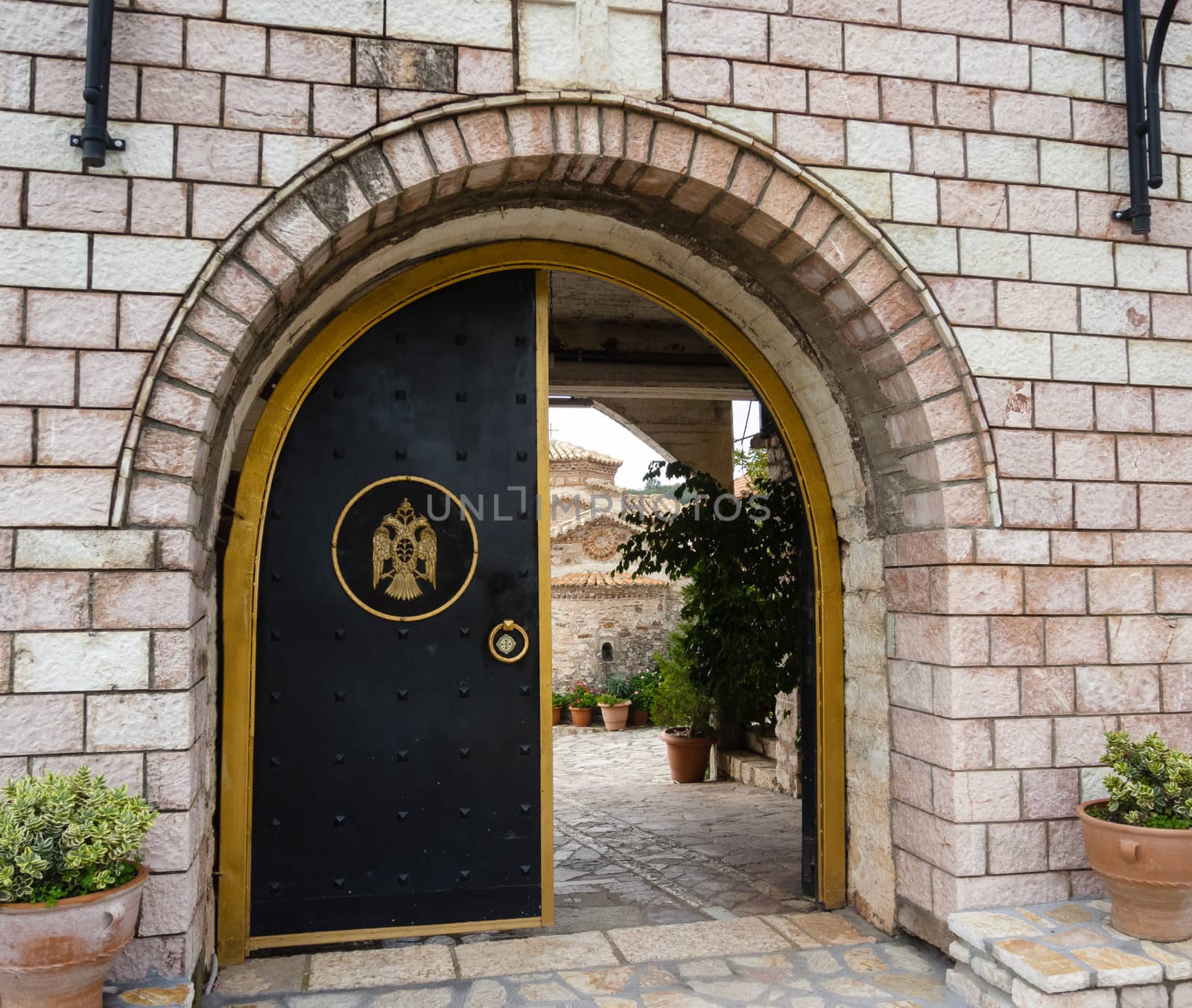 A metal door entrance of a monastery