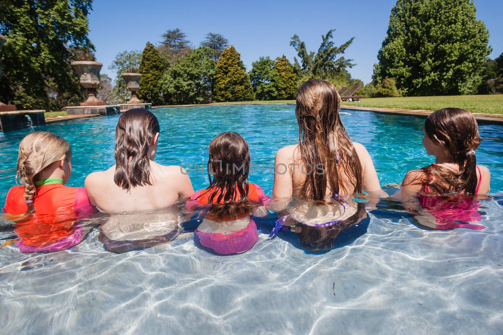 Girls Cousins Seated Water Pool by ChrisVanLennepPhoto