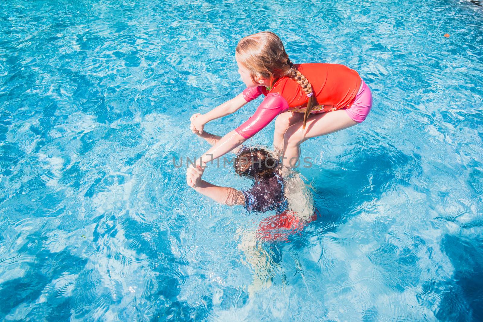 Children Play Swimming Pool by ChrisVanLennepPhoto