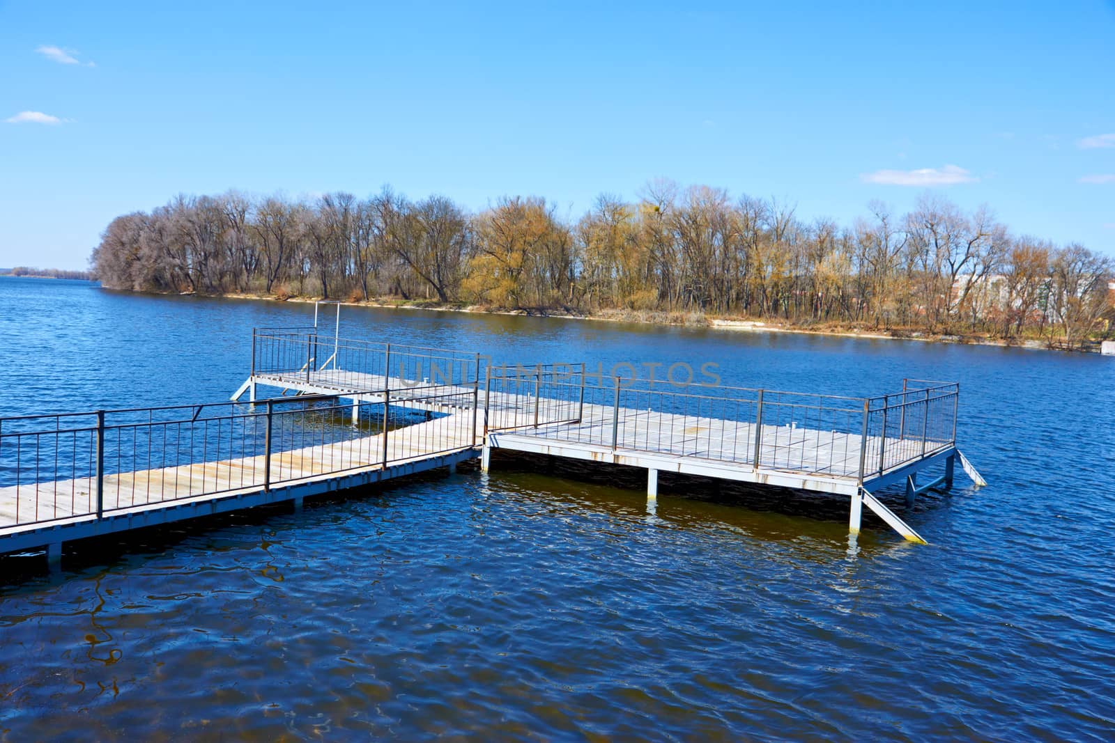 Wooden pier for small river boats an early springtime. Khmelnytsky, Ukraine