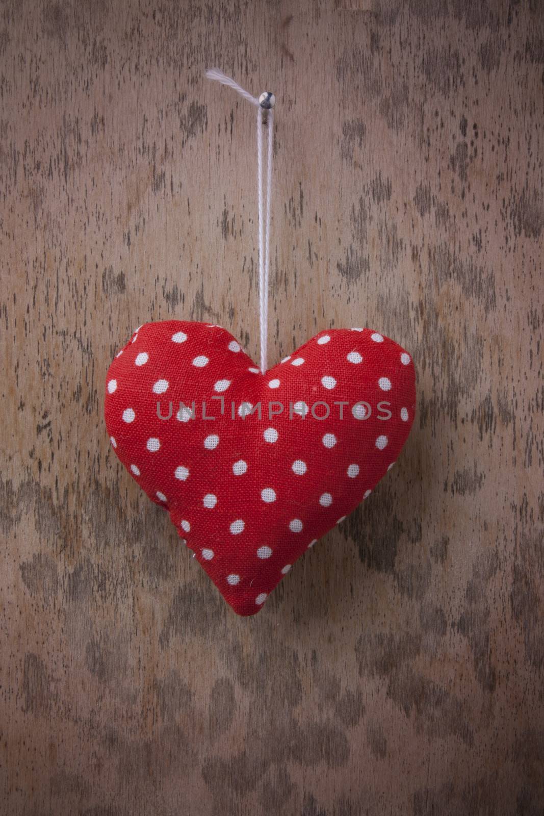 Red heart on wooden background 