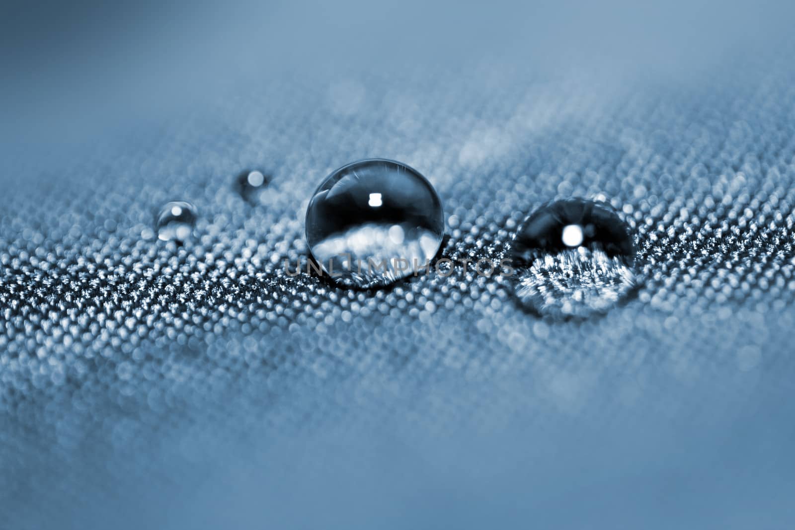 Effect with water drops on blue textile 
