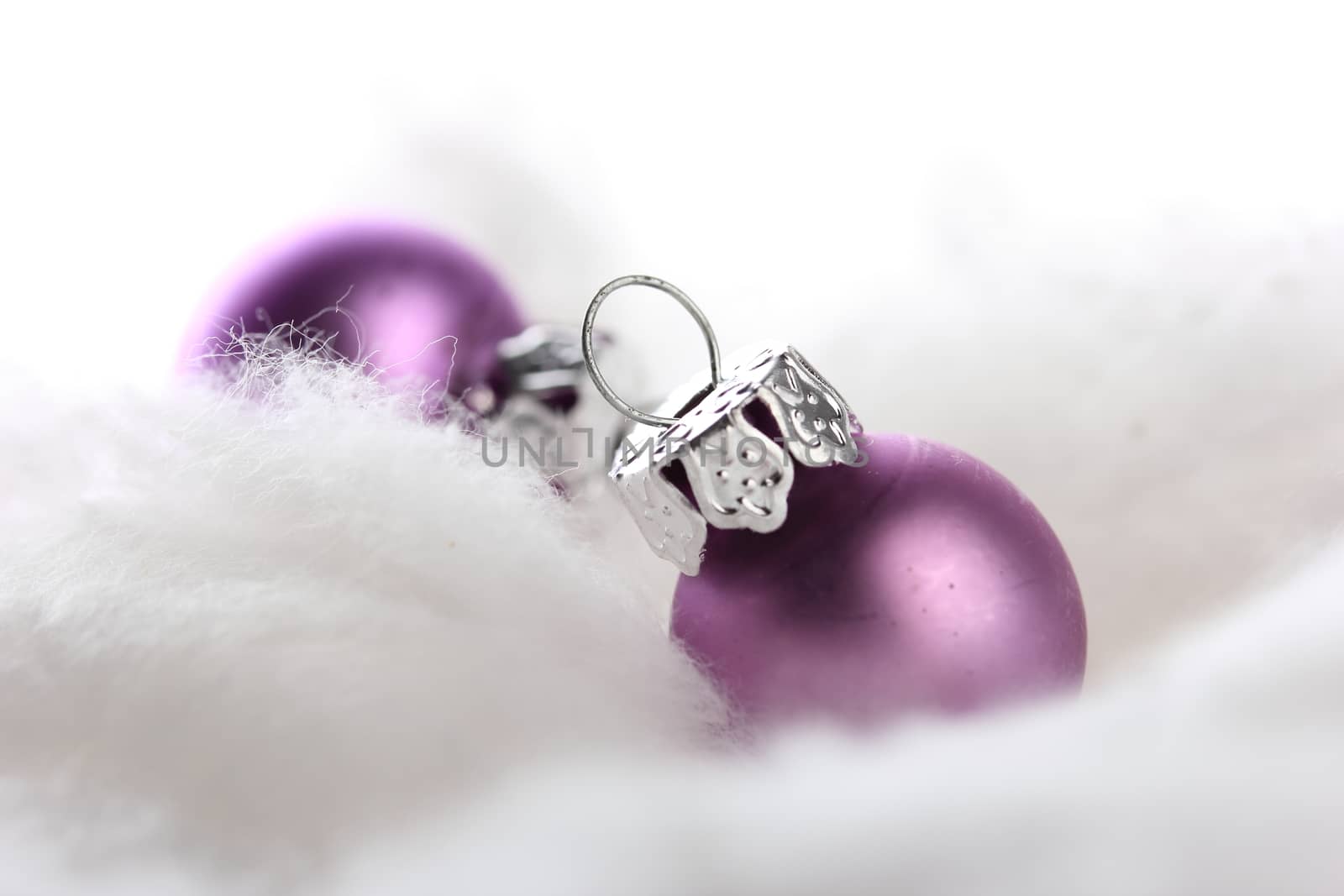 pink christmas balls on snow with white background 