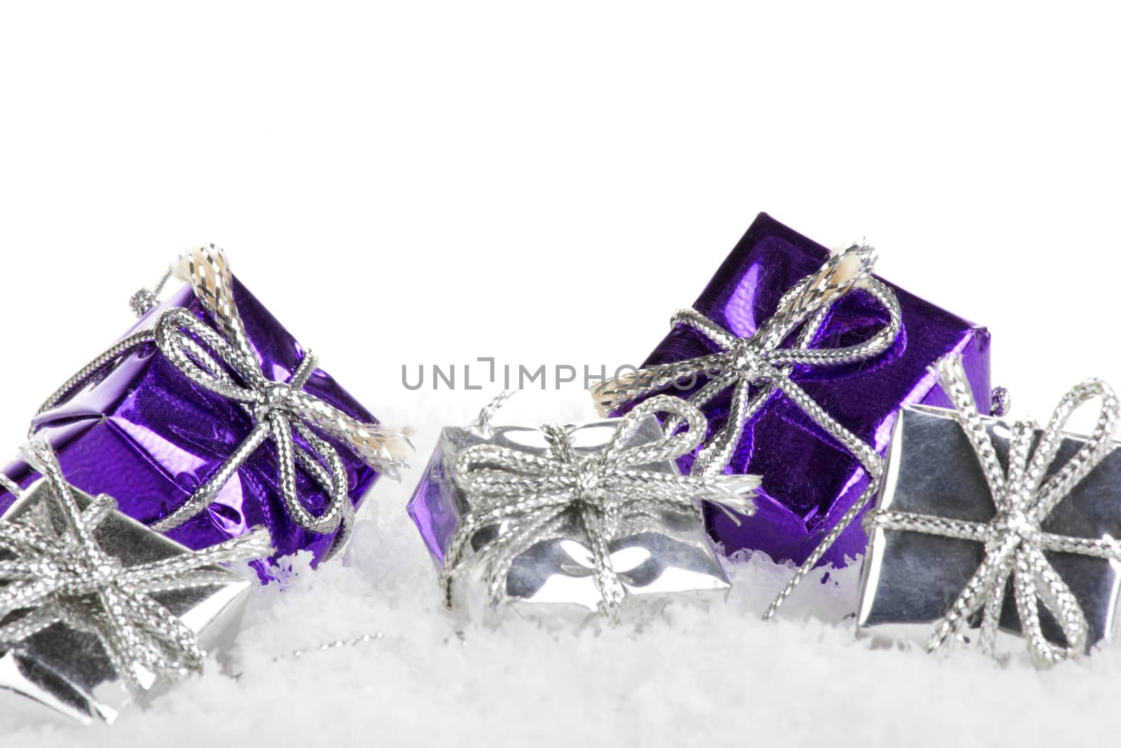 christmas presents purple and silver with snow and white background 