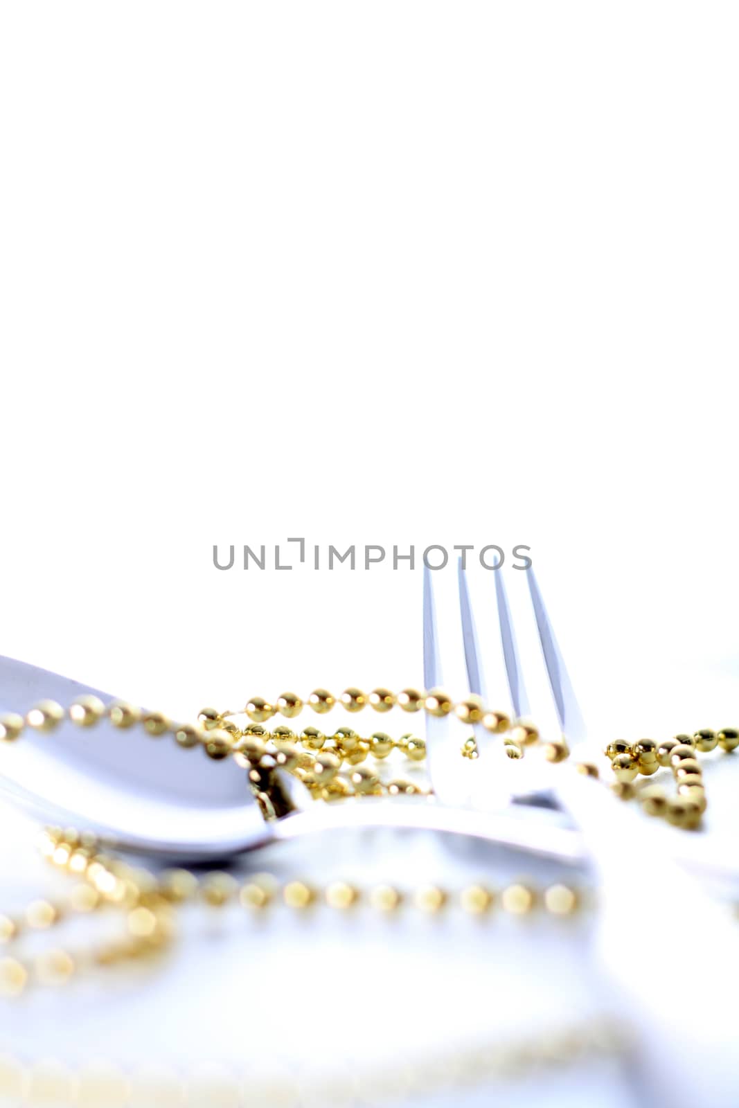 Cutlery, spoon and fork with decoration and white background 