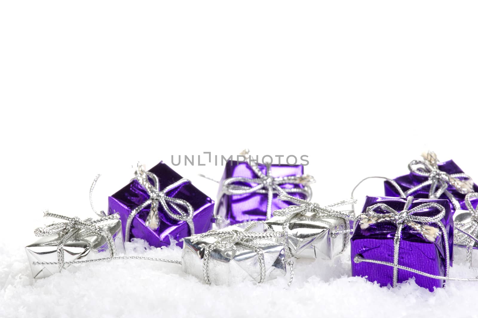 Presents purple and silver on snow with white background 