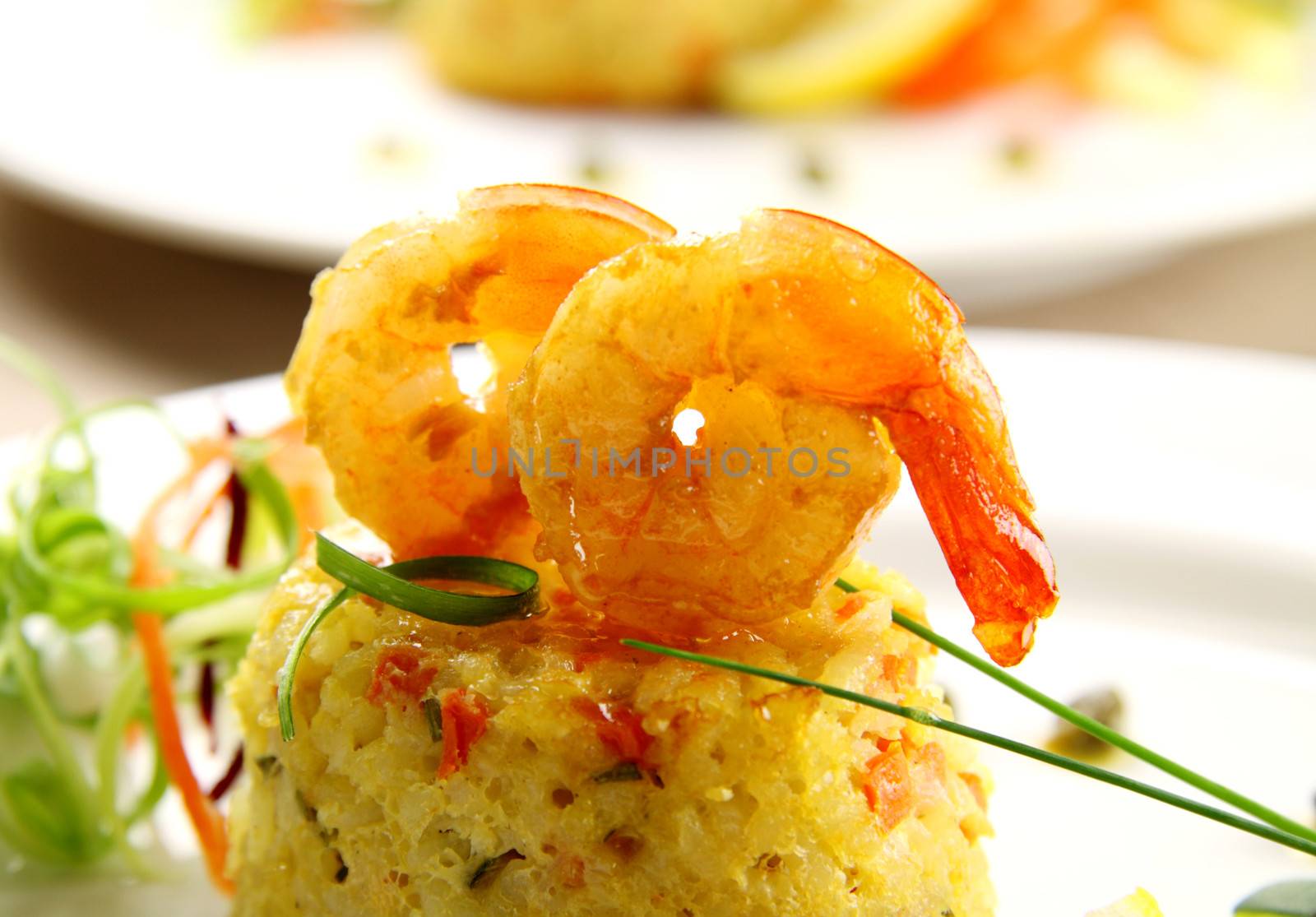 Delicious grilled shrimps on a risotto stack with side salad.