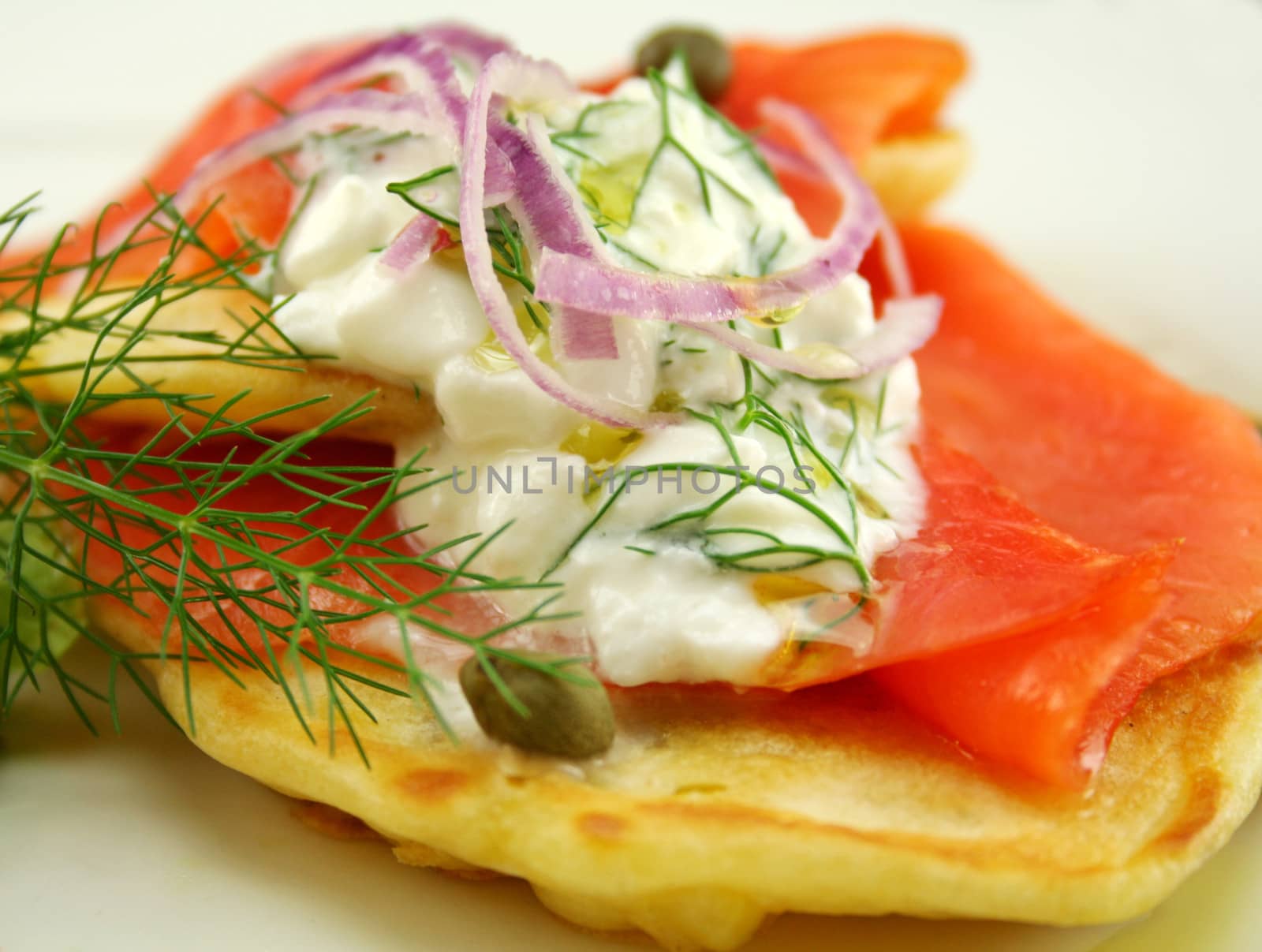 Corn fritters topped with smoked trout with dill, capers and cottage cheese.