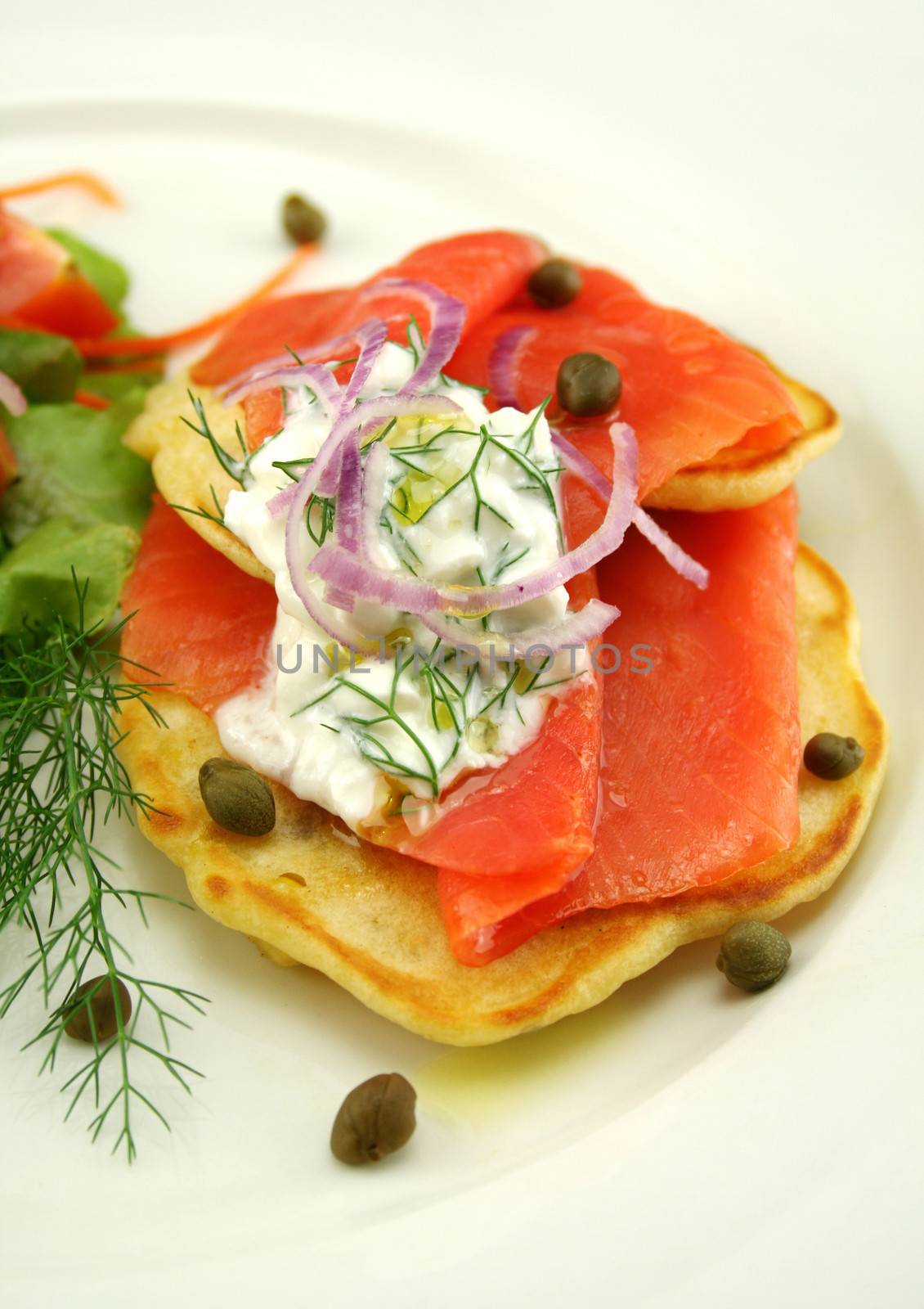 Corn fritters topped with smoked trout with dill, capers and cottage cheese.