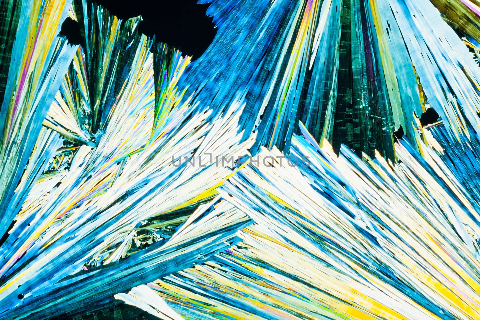 Colorful appearance of crystals of urea or carbamid, a powerful nitrogen fertilizer for agricultural use, in polarized light.