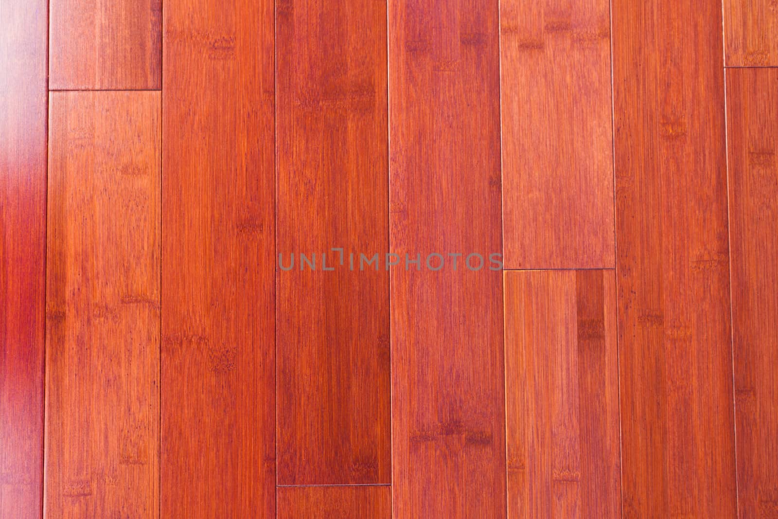 Red-brown stained bamboo plank flooring parquet natural wood grain background texture pattern