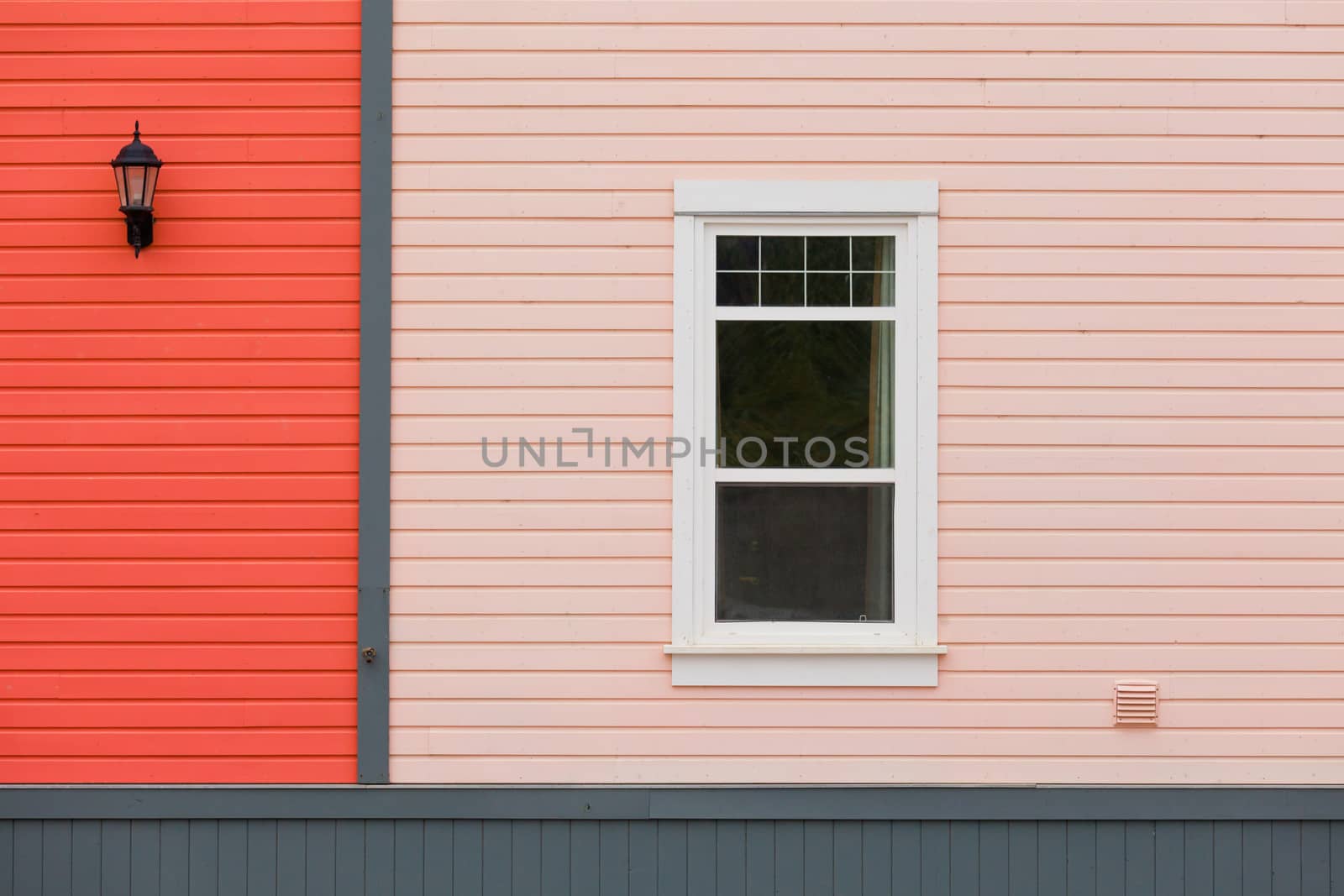 Colorful building facade with window and exterior lamp as architecture background pattern abstract
