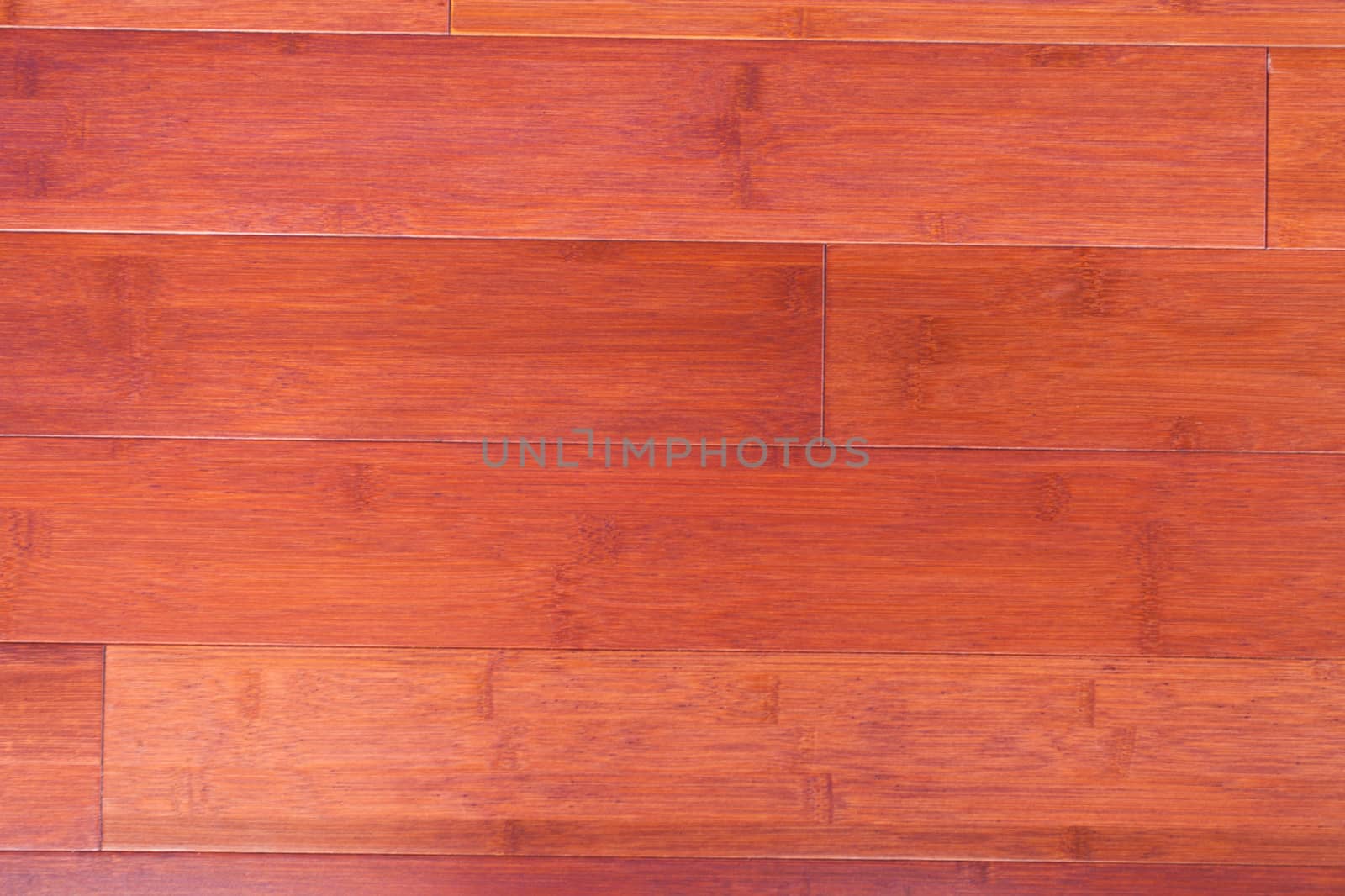 Red-brown stained bamboo plank flooring parquet natural wood grain background texture pattern