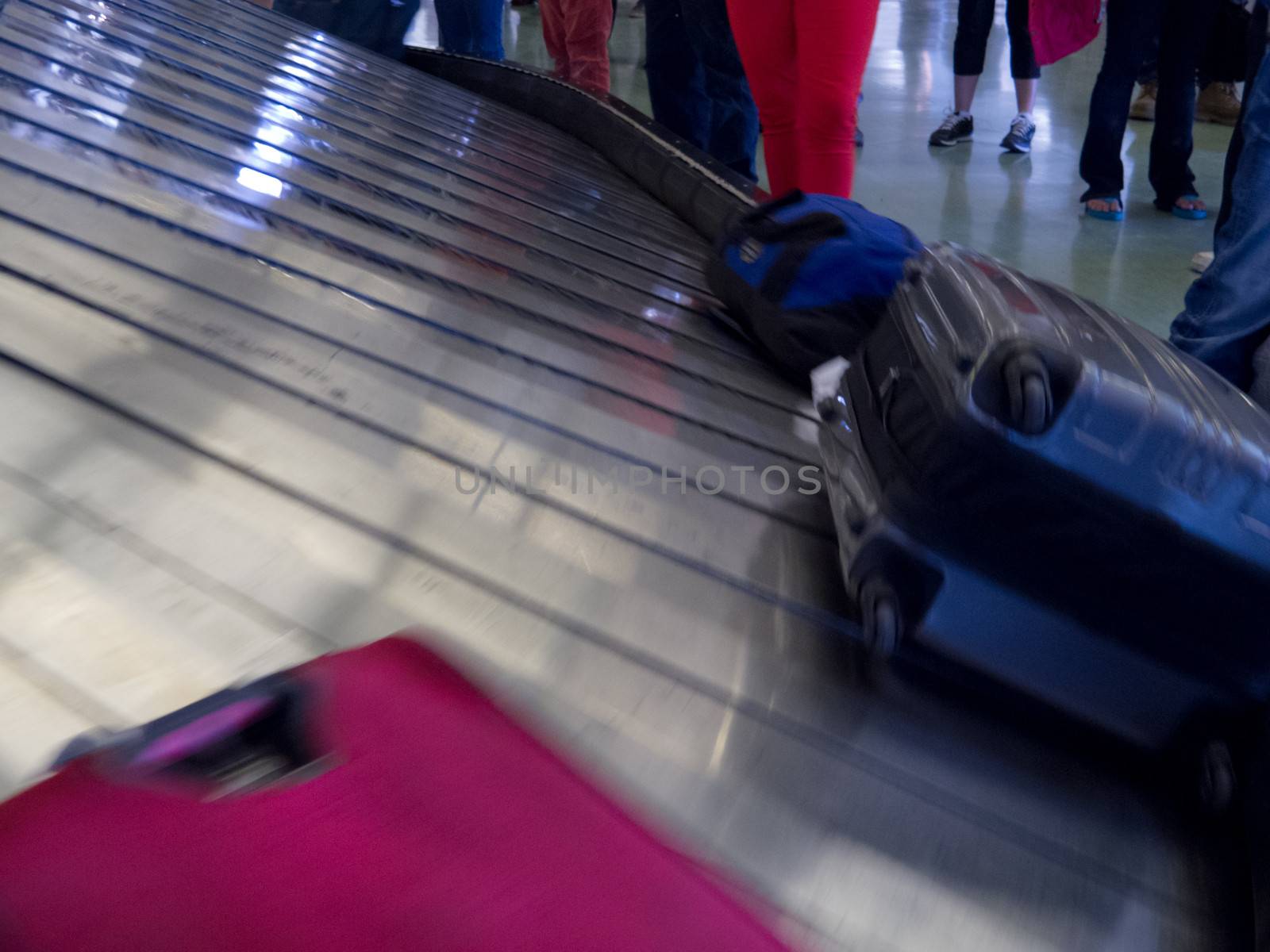 Airport conveyor belt baggage claim people waiting by PiLens