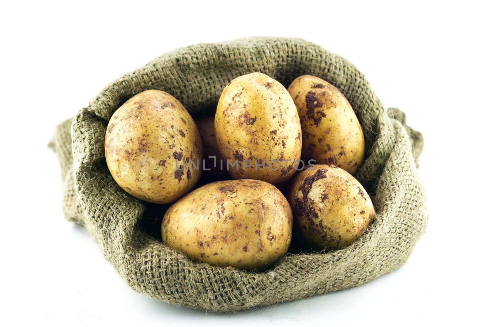 potatoes in burlap sack isolated on white background