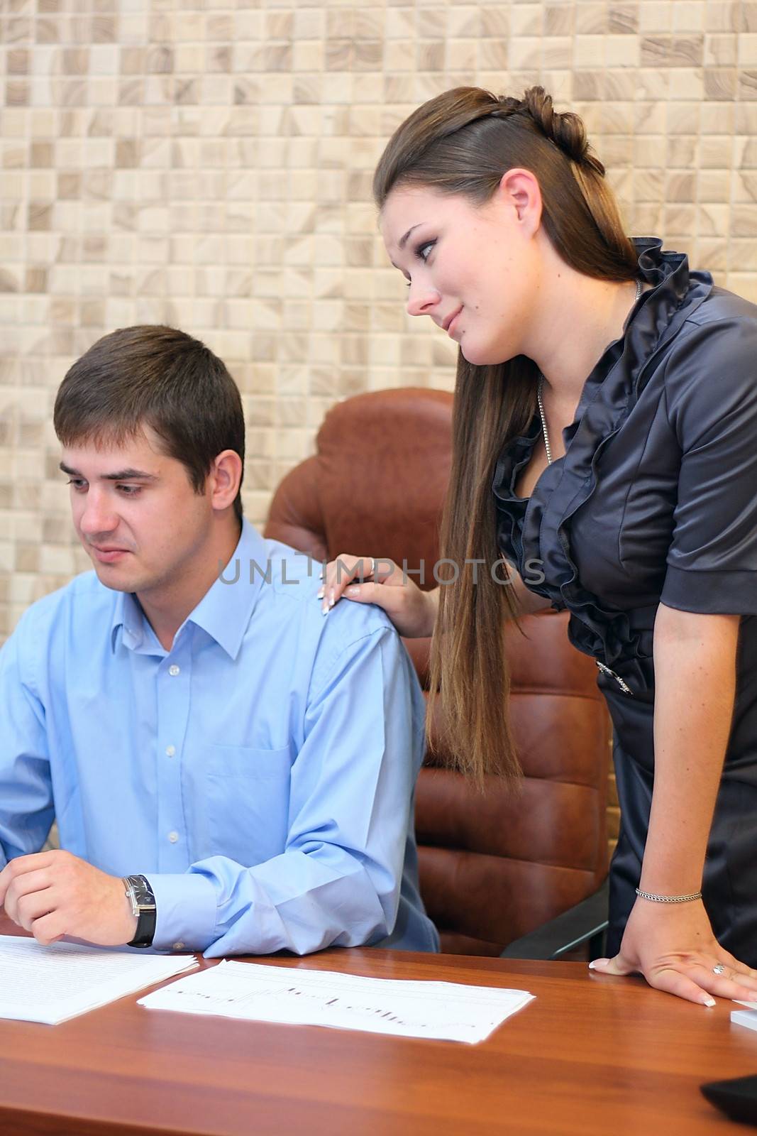 Girl and man working together in the office with papers