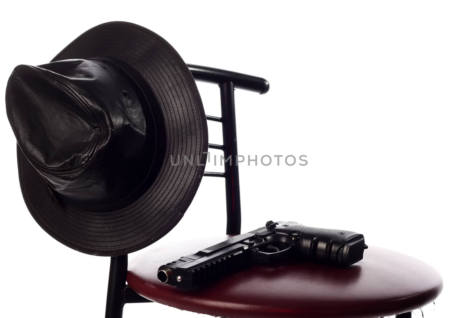 Gun and hat on the chair isolated on the white