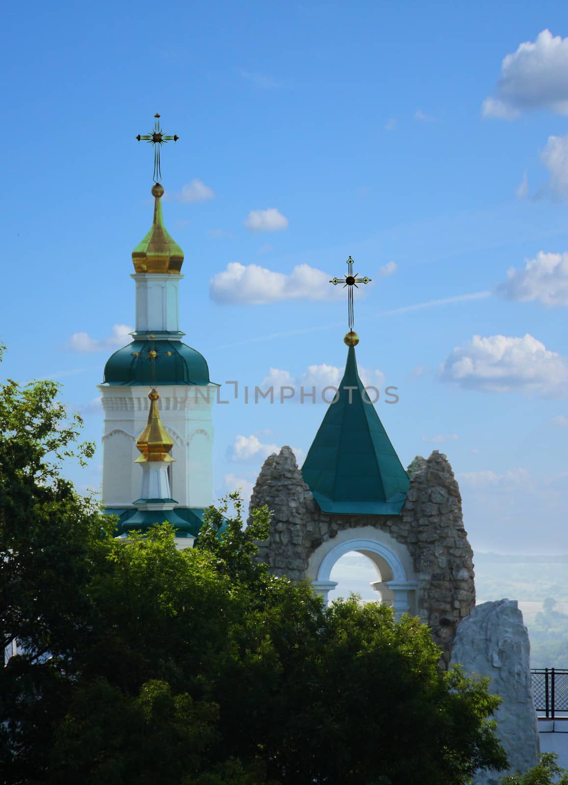 Church on a hill behind trees