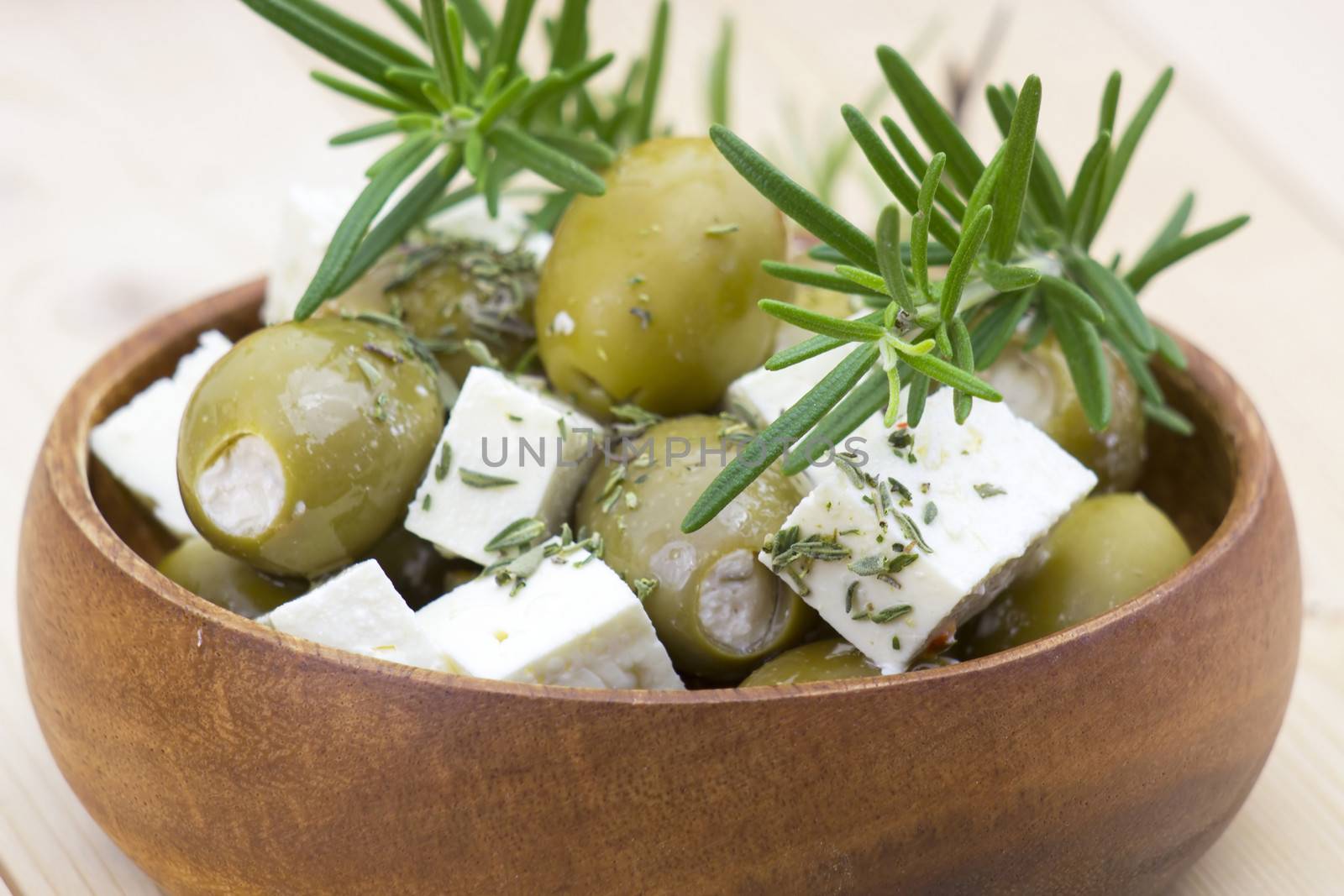 feta cheese and olives with herbs in olive oil