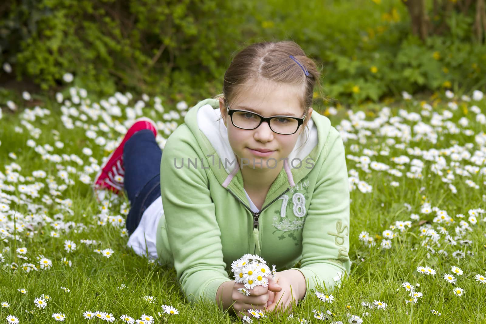 young girl picking daisies