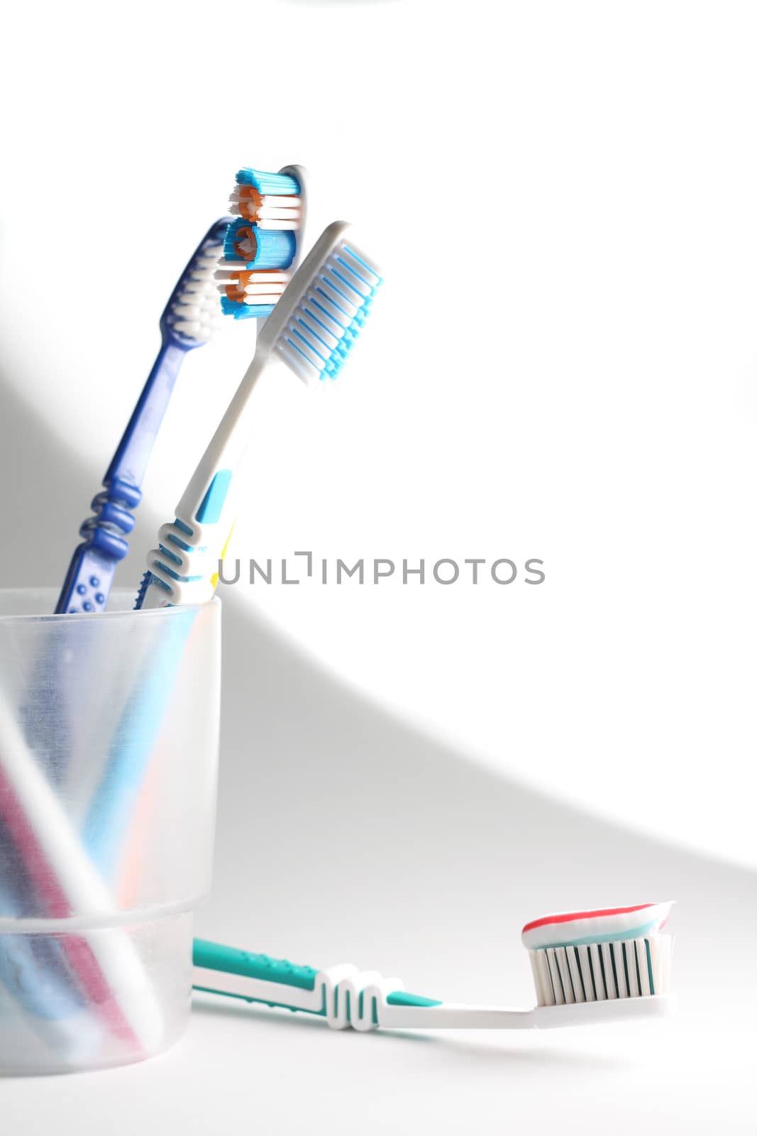 Toothbrushes in a glass by dedmorozz