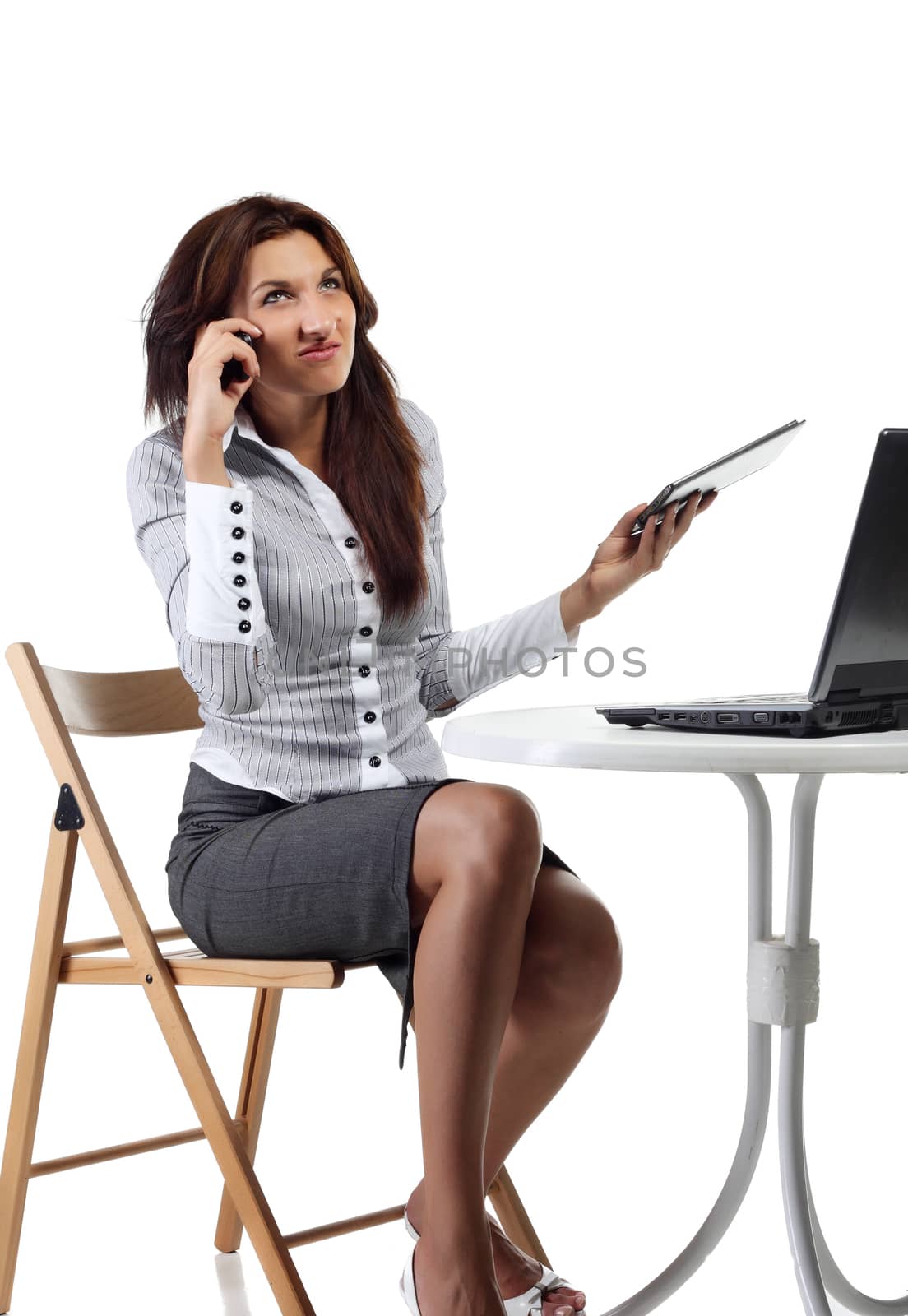 Young women with computer talking by phone