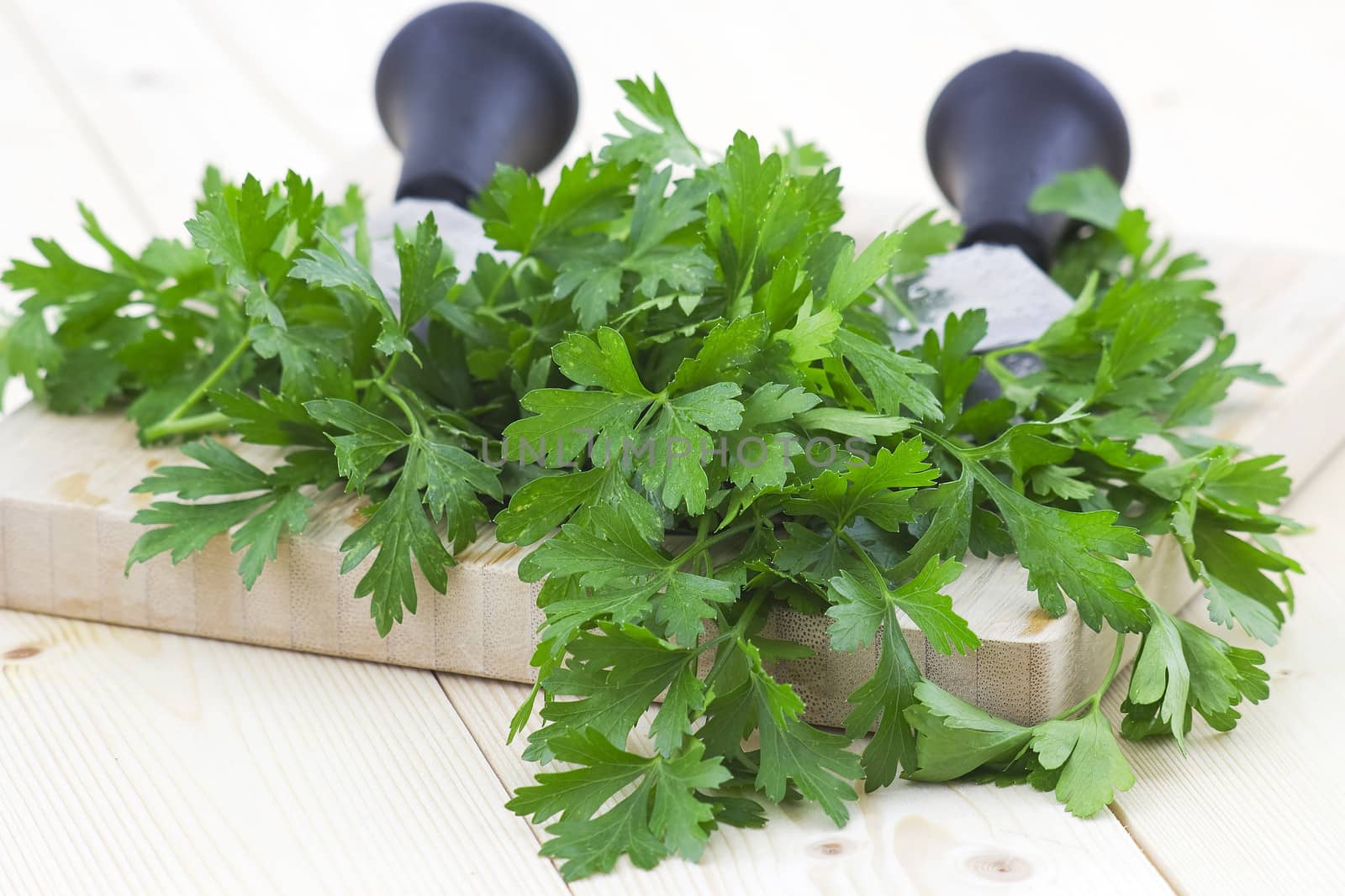 Freshly chopped parsley on wooden cutting board