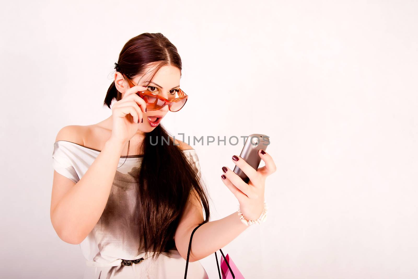 portrait of attractive fashion model with cell phone
