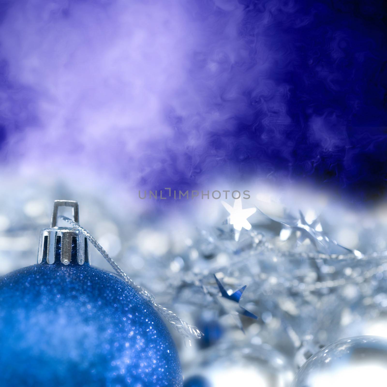  Bright Christmas ornament blue ball and stars out of focus with copy space for text