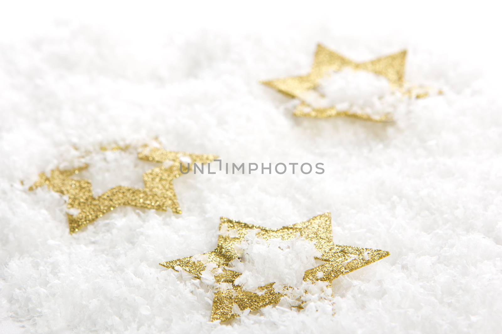 golden christmas stars on artificial snow 