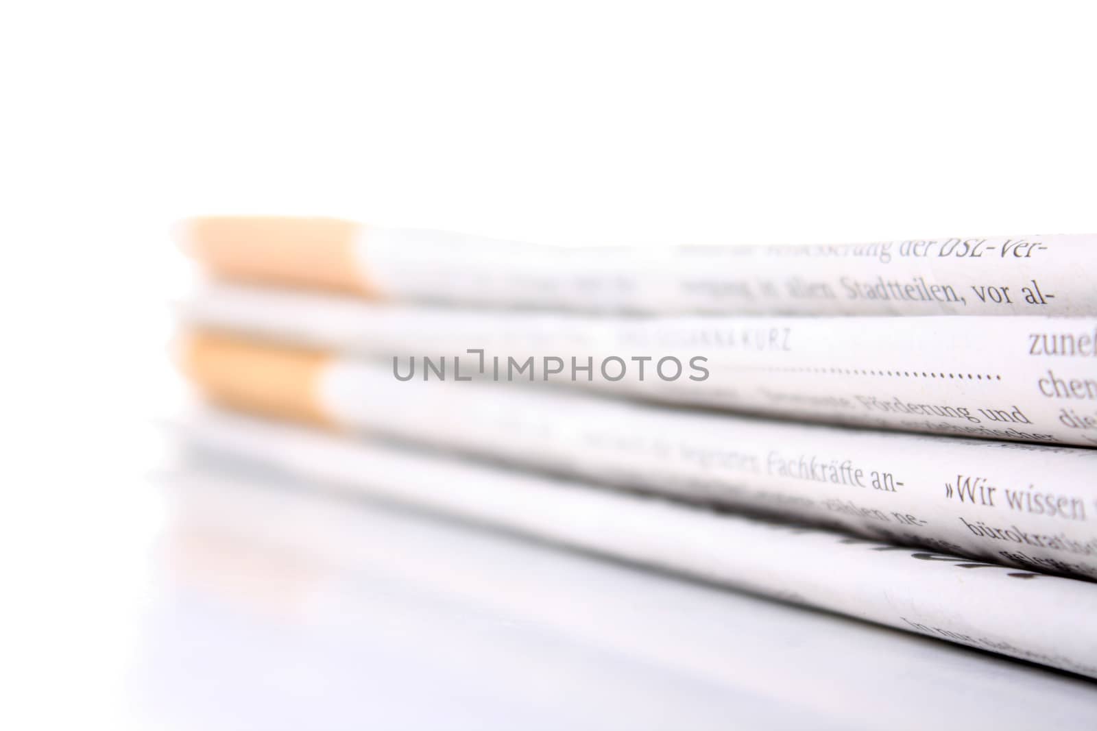several newspaper stacked with a white background 