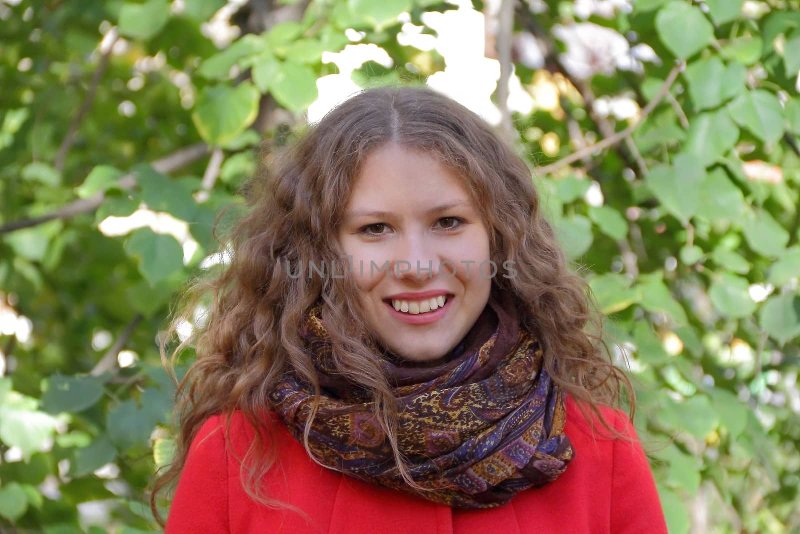 Image of beautiful young woman with autumn leaves