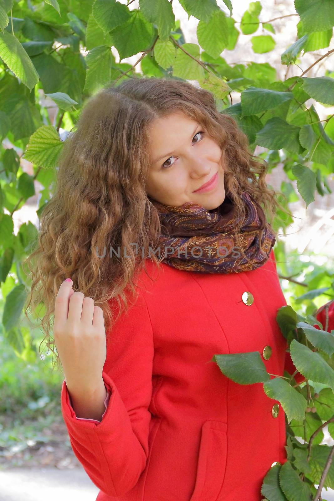 Image of beautiful young woman in red coat