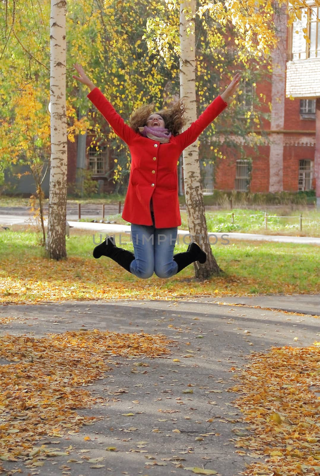 Image of beautiful young woman with autumn leaves