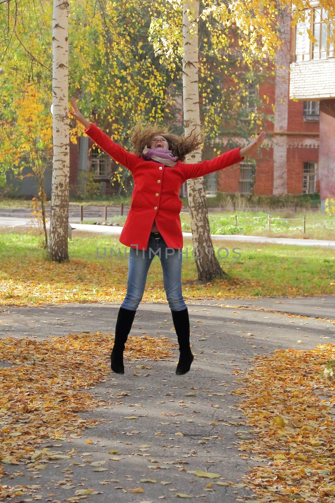 Image of beautiful young woman with autumn leaves