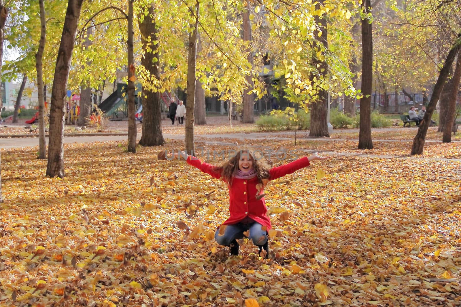 Image of beautiful young woman with autumn leaves
