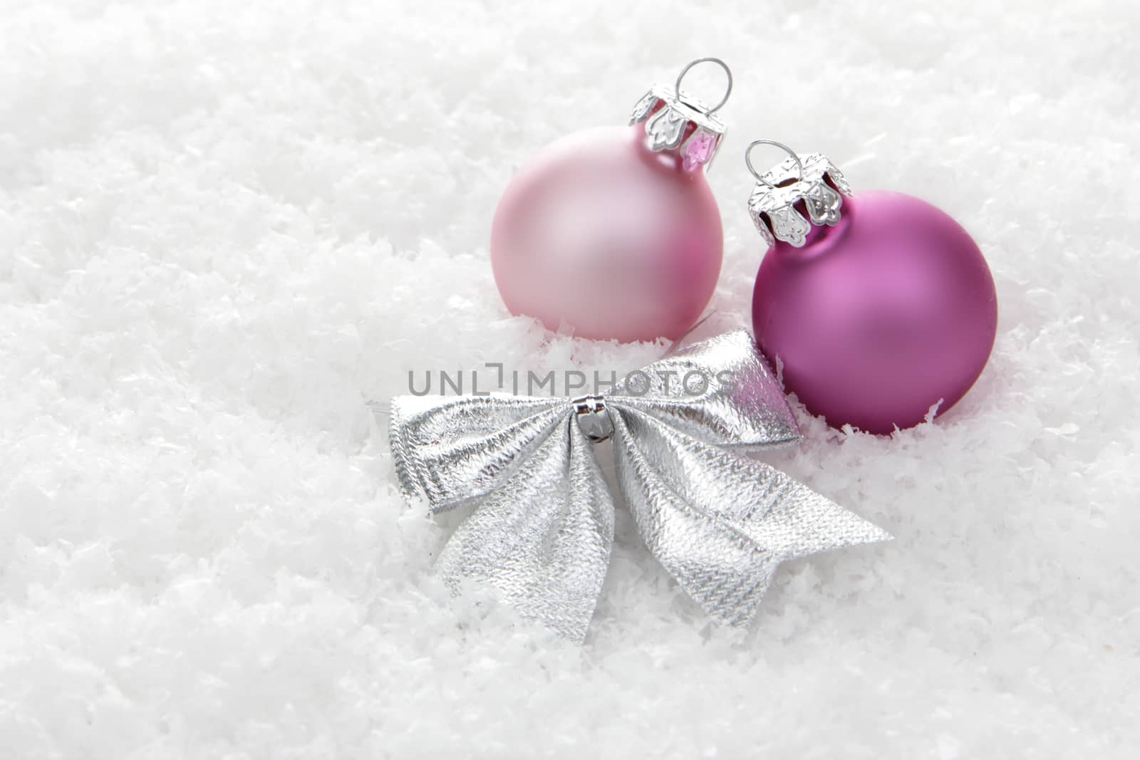 pink christmas balls with loop on snow 